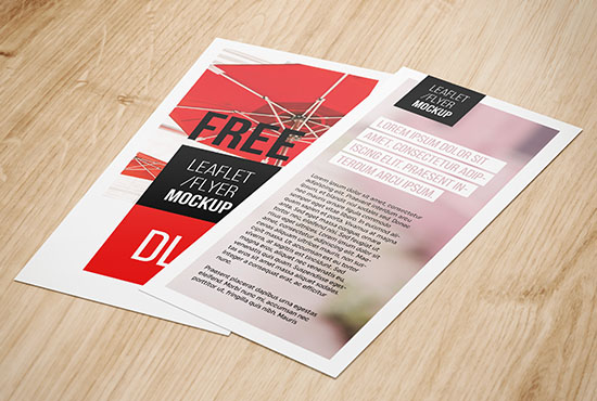 DL flyers lying on wood background